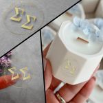 Transparent wedding favor labels with champagne color couple initials and date for candles and custom gifts.