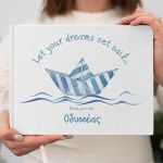 Personalized guest book with striped paper boat design.