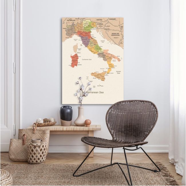 Italy map canvas print, minimalist, with earthy tones, hanging on white wall above wooden bench.