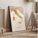 Italy map canvas print, vintage style, leaning on beige wall next to wooden furniture.