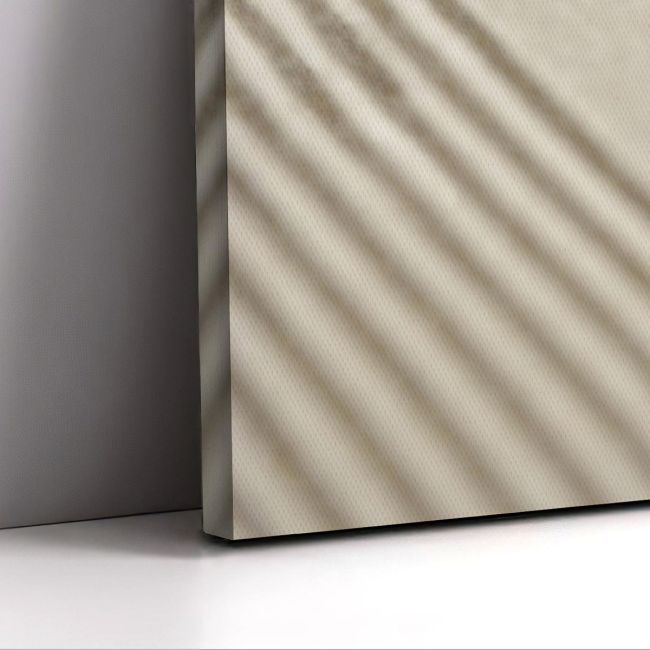 Vertical minimalist canvas print, beige textured with diagonal shadows, leaning on a grey wall, on white surface.