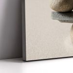 Canvas print 'Stones scale'. Minimalist composition of stacked natural stones, on wall.
