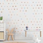 Brown/blue star wall stickers in a child's room. Material: vinyl. Modern, playful style.