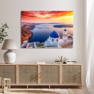 Photographic canvas: Santorini sunset, blue domes, red cliffs. Mounted on a white wall. 2