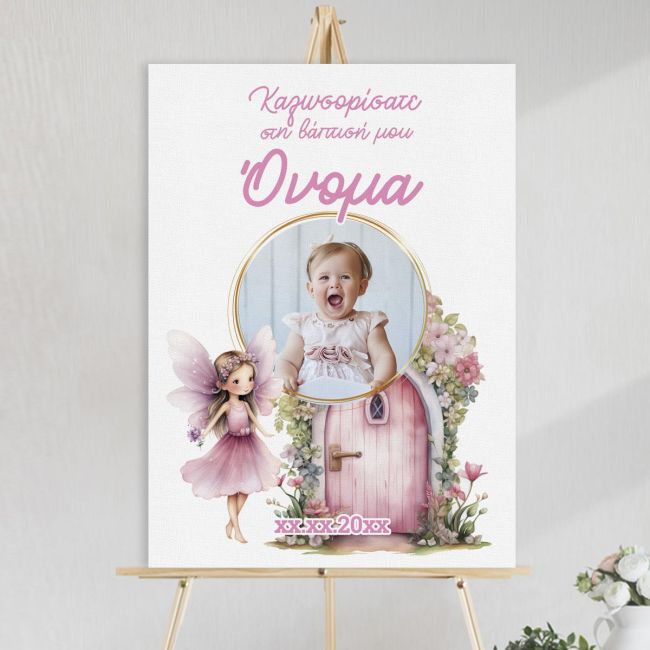 Christening canvas board with baby photo in a gold circle, a fairy, and a pink door, set on a wooden easel.