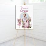 Christening canvas board with a fairy, magic door, and baby photo, placed on a wooden easel.