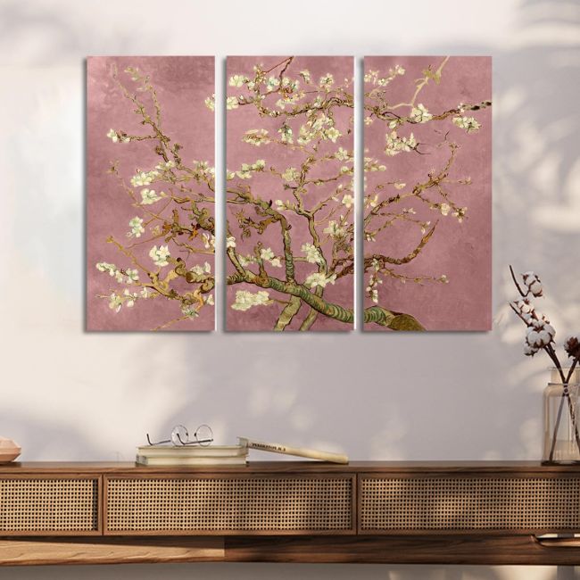 Triptych canvas of Van Gogh's Almond Blossom with a pink background, over a wooden console table.