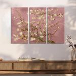 Triptych canvas of Van Gogh's Almond Blossom with a pink background, over a wooden console table.