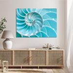 Canvas print: Turquoise spiral nautilus shell, on wall above wooden sideboard.