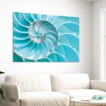 Turquoise nautilus seashell canvas print on white wall above sofa in modern living room.