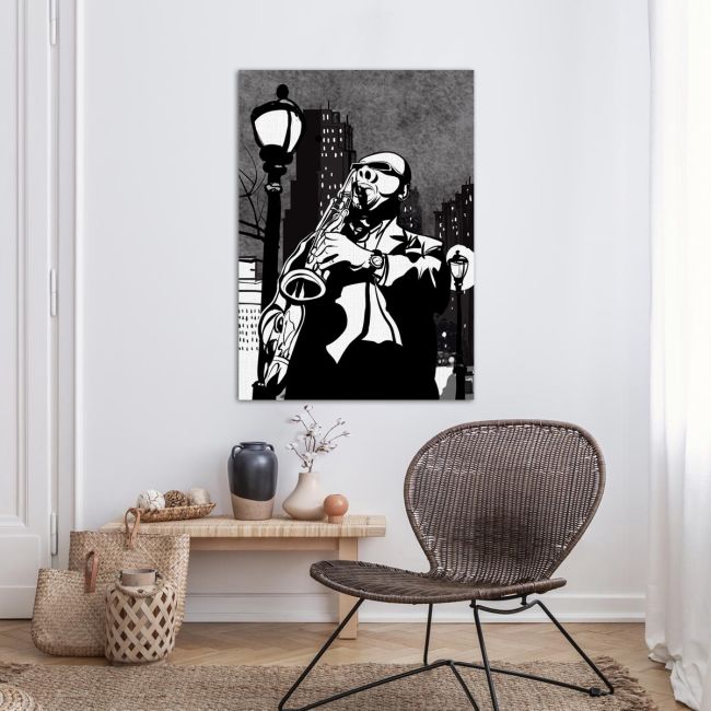Canvas print Saxophone player in a street at night