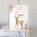 Baptism reception board with fawn & pink flower illustration, white frame, displayed on wooden easel.