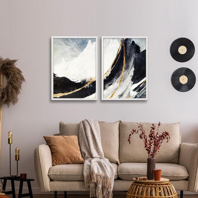 Diptych canvas print with abstract mountains and golden lines above a sofa in a living room