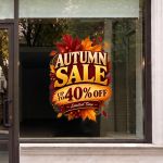 Autumn sale window sticker with leaves on a glass store shopfront.