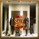 Autumn sale 40% off window sticker on a store display with mannequins