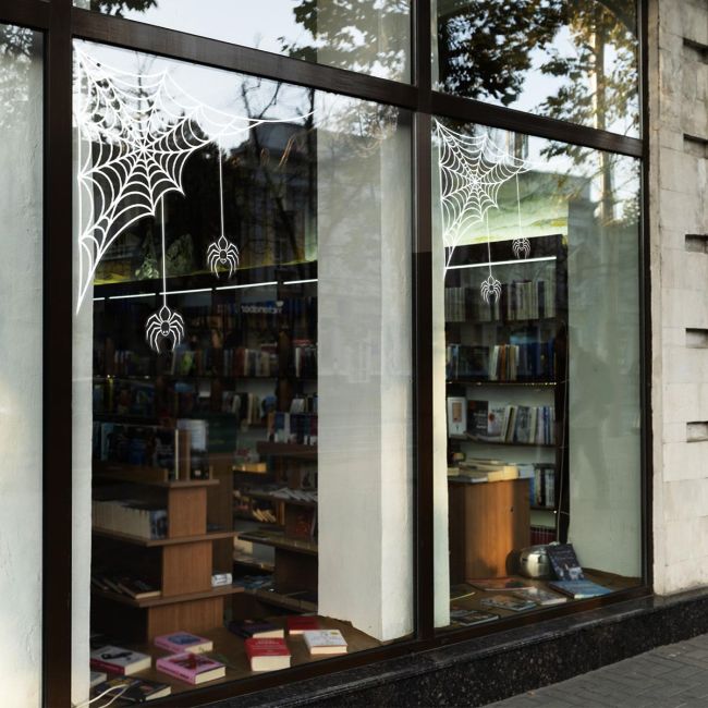 White Halloween spider web and spider window sticker in bookstore shopfront corners
