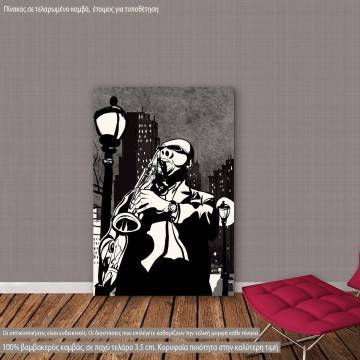 Canvas print Saxophone player in a street at night