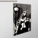 Canvas print Saxophone player in a street at night, side