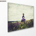 Canvas print Young girl in a sage flower field, side